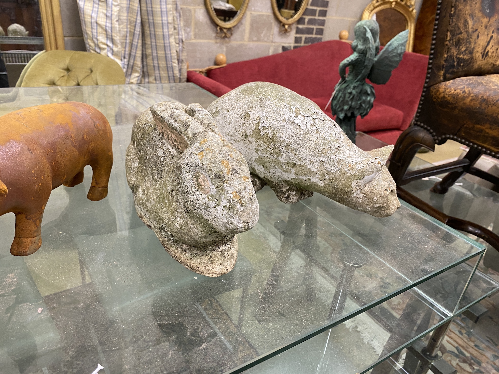 A pair of cast metal garden pig ornaments and a cast stone cat and rabbit ornament, largest length 34cm